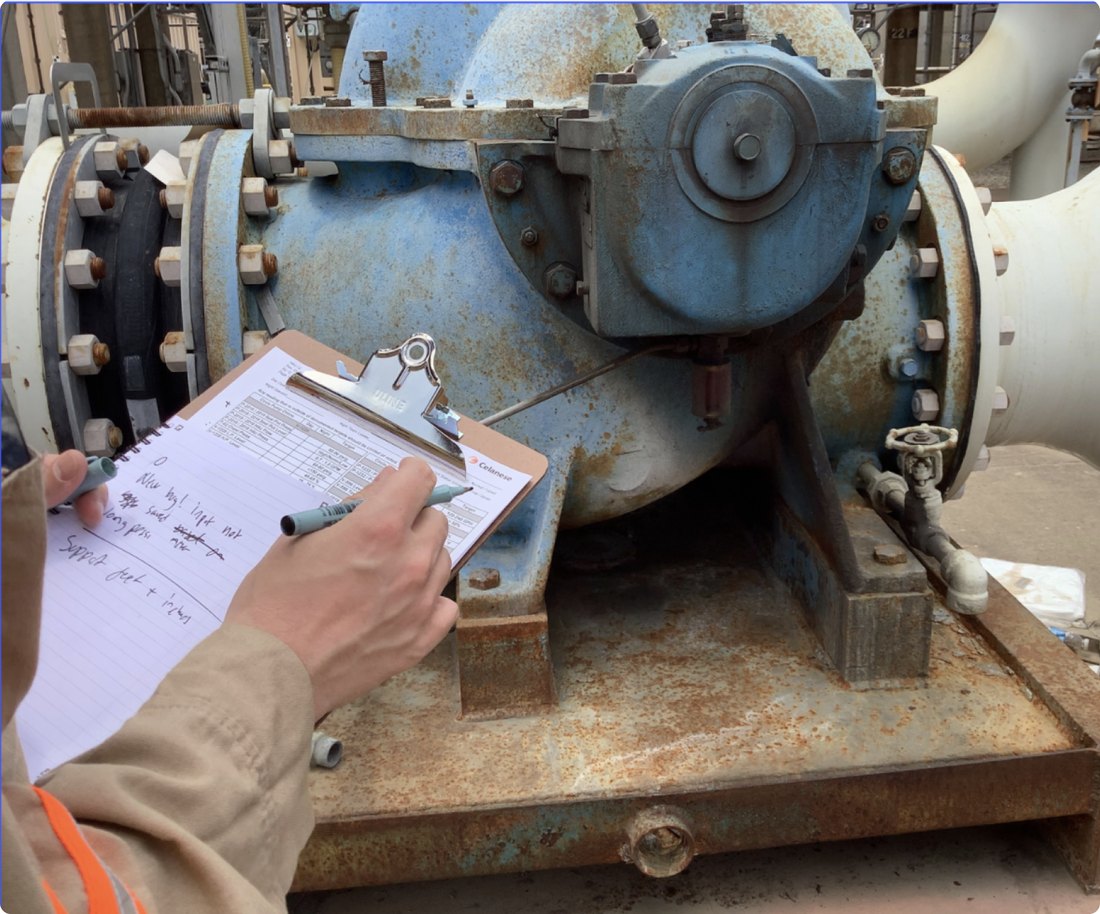 Engineer recording readings at a large valve